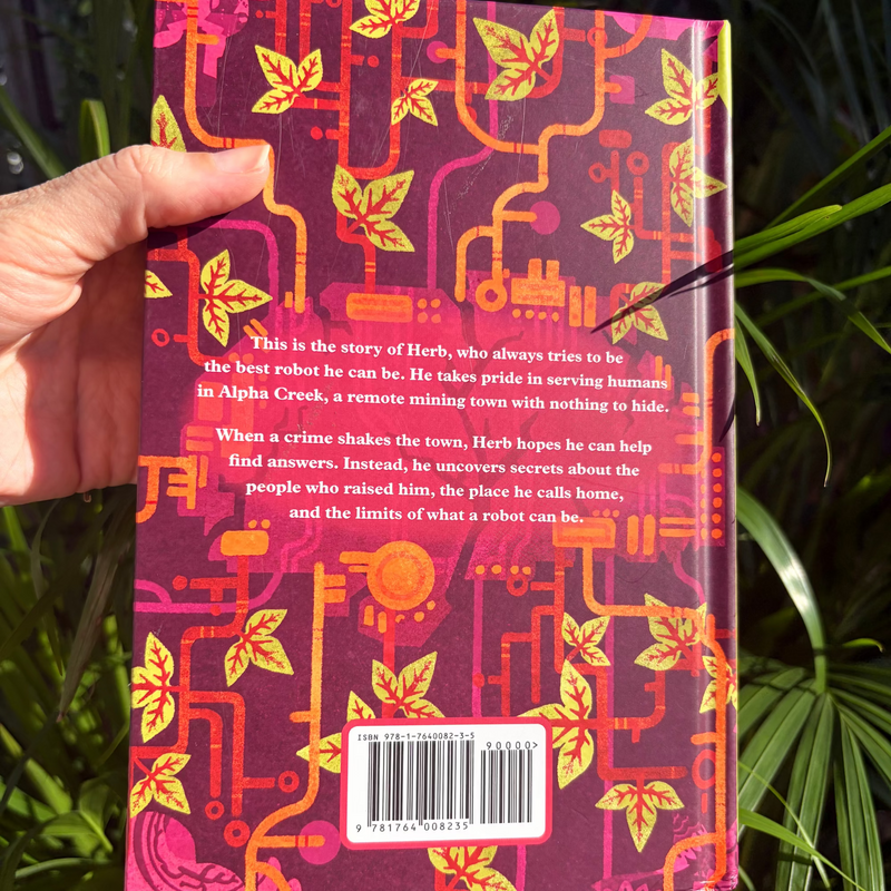 Alpha Creek held at an angle, showing the page edges